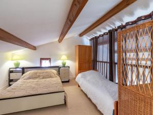 a bedroom with two beds and a window at Holiday Home Résidence Les Lauriers by Interhome in Meschers-sur-Gironde