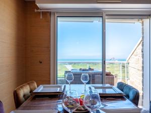 a dining room with a table and a large window at Apartment Er Palouen by Interhome in Quiberon