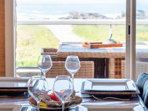 two wine glasses sitting on a table with a view at Apartment Er Palouen by Interhome in Quiberon