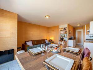 a living room with a table and wine glasses at Apartment Er Palouen by Interhome in Quiberon