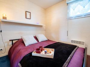 a bedroom with a bed with a tray on it at Apartment Er Palouen by Interhome in Quiberon