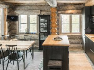 a kitchen with wooden walls and a table and chairs at Holiday Home Villa toprakka b by Interhome in Sirkka