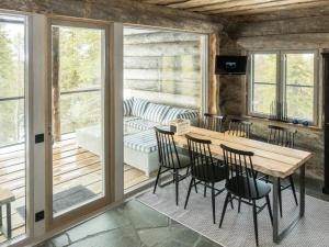 a screened in porch with a table and chairs at Holiday Home Villa toprakka b by Interhome in Sirkka