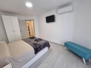 a bedroom with a bed and a blue couch at Apartamentos en Denia frente al Puerto! in Denia