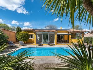 a villa with a swimming pool and a house at Holiday Home Le Clos du Mûrier by Interhome in Cogolin