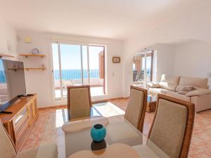 a living room with a table and chairs and a couch at Apartment Azul Celeste by Interhome in Benitachell