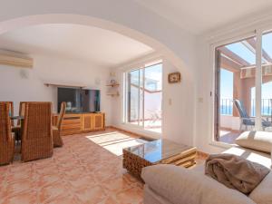 a living room with a couch and a tv at Apartment Azul Celeste by Interhome in Benitachell +18 photos