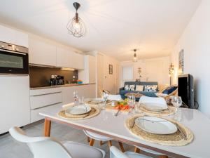 a kitchen and living room with a white table and chairs at Apartment Résidence Coté Baie by Interhome in Saint-Pierre-Quiberon