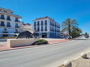 a street with a statue in the middle of a road at Apartamentos en Denia frente al Puerto! in Denia