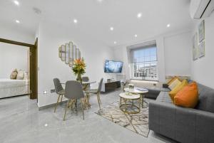 a living room with a couch and a table at Bryanston Apartments in London