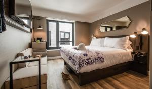 a bedroom with a large bed and a mirror at Pestana Park Avenue in New York
