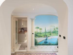 uma cozinha com uma pintura de uma piscina em Apartment Grimaldi by Interhome em Mortola Superiore