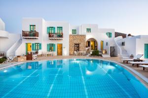 a swimming pool in front of a villa at Aria Boutique Hotel in Chora Folegandros