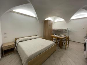 a bedroom with a bed and a table in it at Apartment Tra Sole e Mare by Interhome in Spotorno