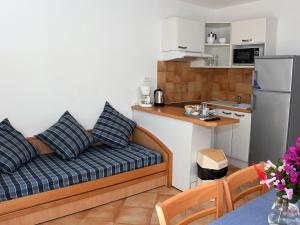 a living room with a couch and a kitchen at Holiday Home T3 Cabine by Interhome in Borgo