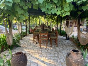 a dining table and chairs under a pergola at Villa Hjort by Interhome in Itri