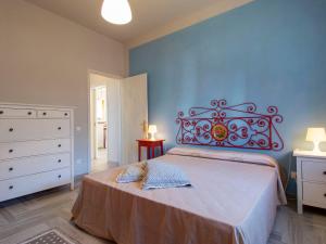 a bedroom with a large bed with a red headboard at Holiday Home Vittoria by Interhome in Marliana