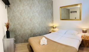 a bedroom with a large bed with a mirror on the wall at Shoreline Apartment Katwijk in Katwijk aan Zee