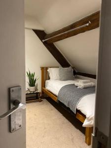 a bedroom with a bed in a attic at The Old Fire Station Ludlow in Ludlow