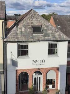a white building with the words no man on it at The Old Fire Station Ludlow in Ludlow