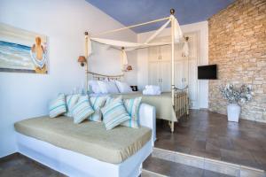 a bedroom with a large bed with a canopy bed at Aria Boutique Hotel in Chora Folegandros