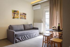 a living room with a couch and a table at Studios Drakontis in Limenas