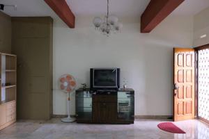 a living room with a television and a fan at Simple Home Taiping 简居 Lakeview in Taiping