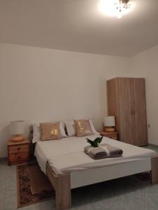 a bedroom with a large bed with two night stands at Summer vibe in Vir