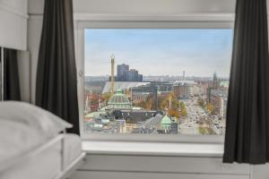 a view of a city from a bedroom window at Danhostel Copenhagen City & Apartments in Copenhagen