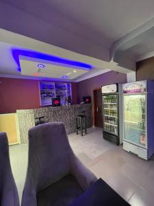 a restaurant with a bar with a drink cooler at Alluring View Hotel - Allen Avenue in Lagos