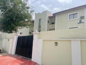 a house with a gate and a fence at Alluring View Hotel - Allen Avenue in Lagos