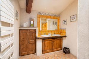 a bathroom with two sinks and a mirror at Pavillon Lou in Crillon-le-Brave +41 photos