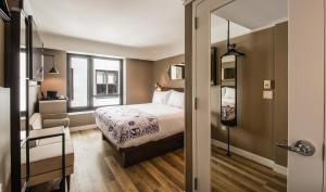 a small bedroom with a bed and a window at Pestana Park Avenue in New York