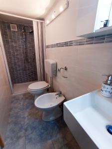 a bathroom with a toilet and a shower and a sink at La Casa del Porto in Catania
