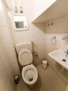 a small bathroom with a toilet and a sink at La Casa del Porto in Catania