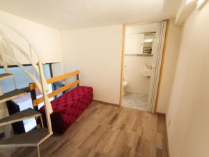 a small room with a bed and a bathroom at La Casa del Porto in Catania