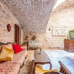 a living room with a couch and a table at Palazzo Morola XIV century in Giovinazzo