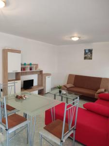 a living room with a table and a couch at Summer vibe in Vir