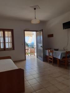 a bedroom with a table and a view of the ocean at Zaga Apartments - Flats in Koroni