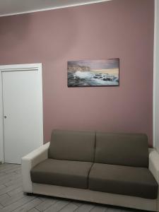 a living room with a couch and a picture on the wall at Il filo di Claudia in Savona
