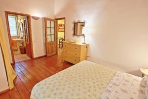 a bedroom with a bed and a dresser and a mirror at Kitrini Luxury Cottage in Zenempisátika +32 photos