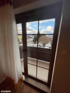 a room with a window with a view of a balcony at Apartament U Aśki in Jelenia Góra