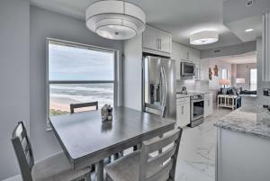 a kitchen with a table with a view of the ocean at Oceanfront Ormond Beach Condo - Steps to Shore! in Ormond Beach