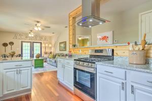 a kitchen with white cabinets and a stove top oven at Bayou La Batre Stilted House on Snake Bayou! in Bayou La Batre