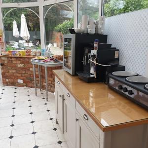 a kitchen with a stove top oven and a microwave at St Margaret's Hotel in Oxford