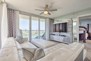 a living room with a white couch and a tv at The Terrace at Pelican Beach Resort: View + Pool! in Destin