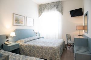 Кровать или кровати в номере Hotel Ariston