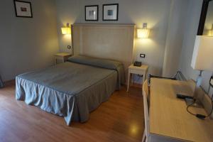Postel nebo postele na pokoji v ubytování Hotel Taormina