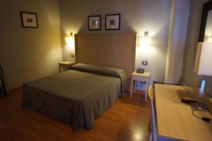 Postel nebo postele na pokoji v ubytování Hotel Taormina