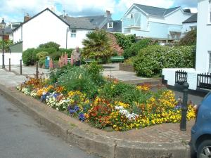un jardín con flores de colores en una calle en Dolphin Cottage 50m from Shaldon Beach! en Shaldon